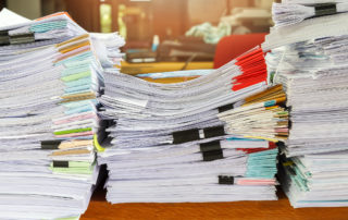 a-stack-of-documents-that-show-the-business-benefits-of-managed-print-services