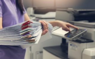 businesswoman-with-documents-using-a-printer-with-managed-print-services-mps-that-saves-money-and-costs