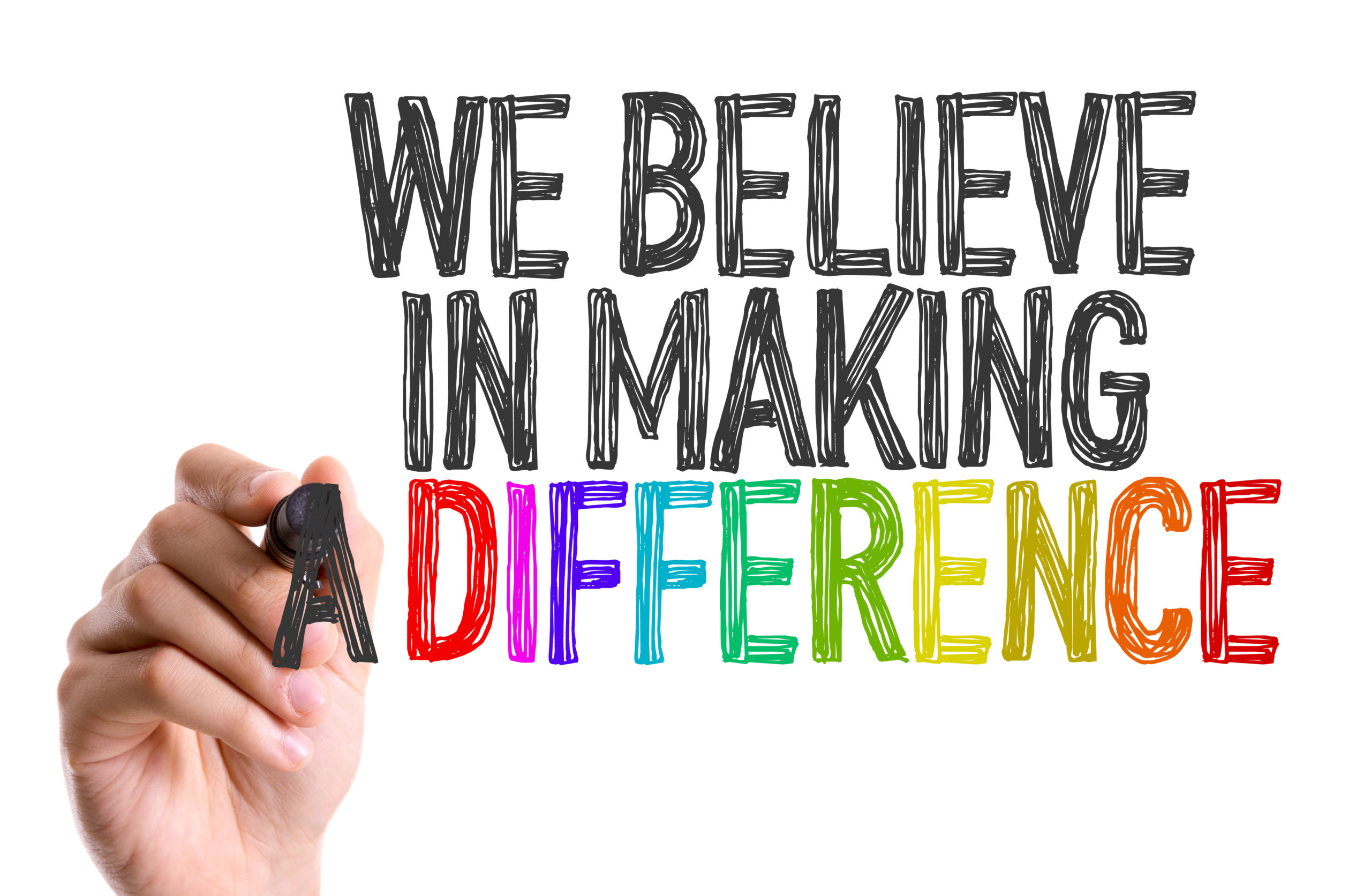 Hand with marker writing: We Believe in Making a Difference