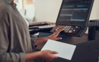 Close up image of a businesswoman interfacing with an office copier