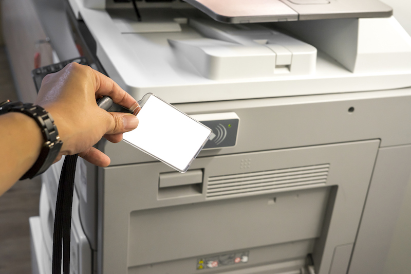 man hold card for scanning key card to access Photocopier man hold card for scanning key card to access Photocopier