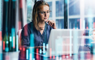 An IT Consultant sits in front of a laptop