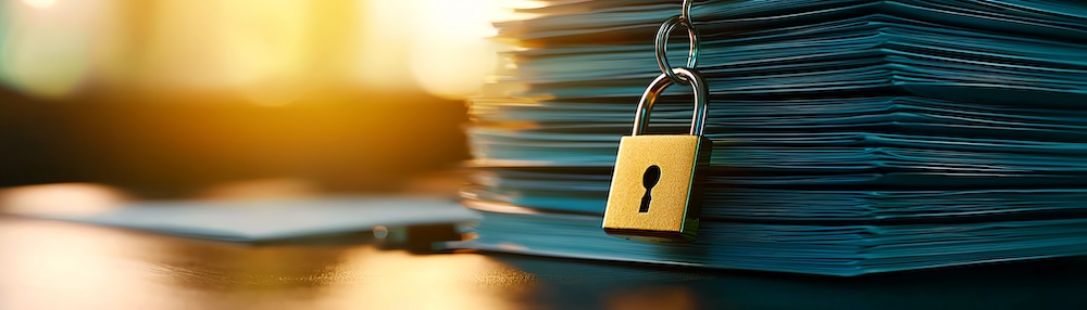 Locked padlock on a stack of documents representing document security and confidentiality in a business environment.