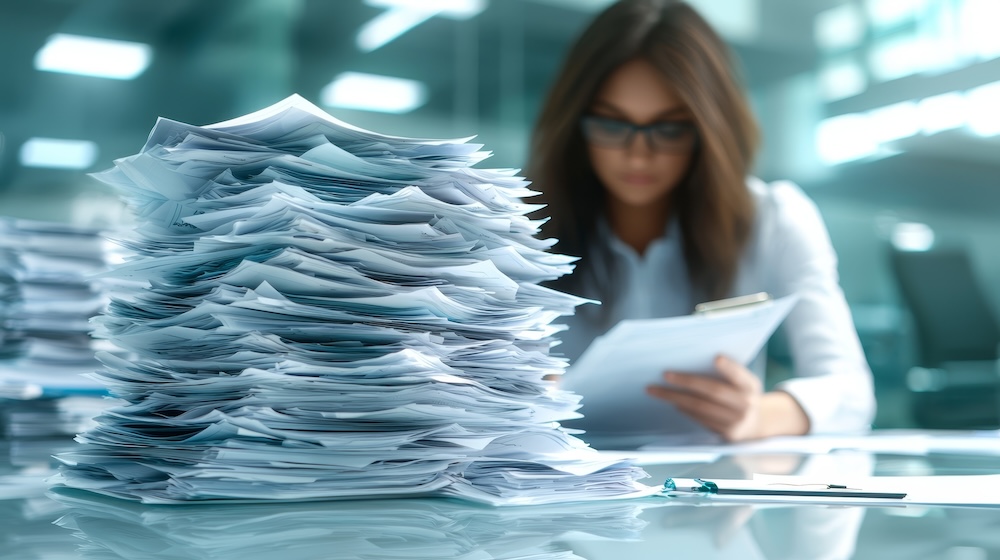 women reviewing documents. too much paperwork concept. need for document workflow.