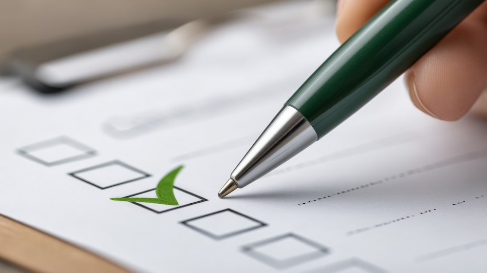 Green pen checking items on printed list for professional review and organization