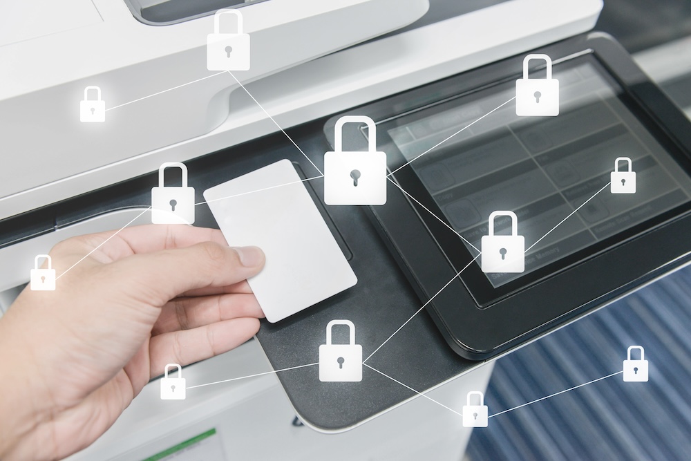 Business man hand is using smart card to printing document with locked key icon for data protection concept. Secure printing concept.