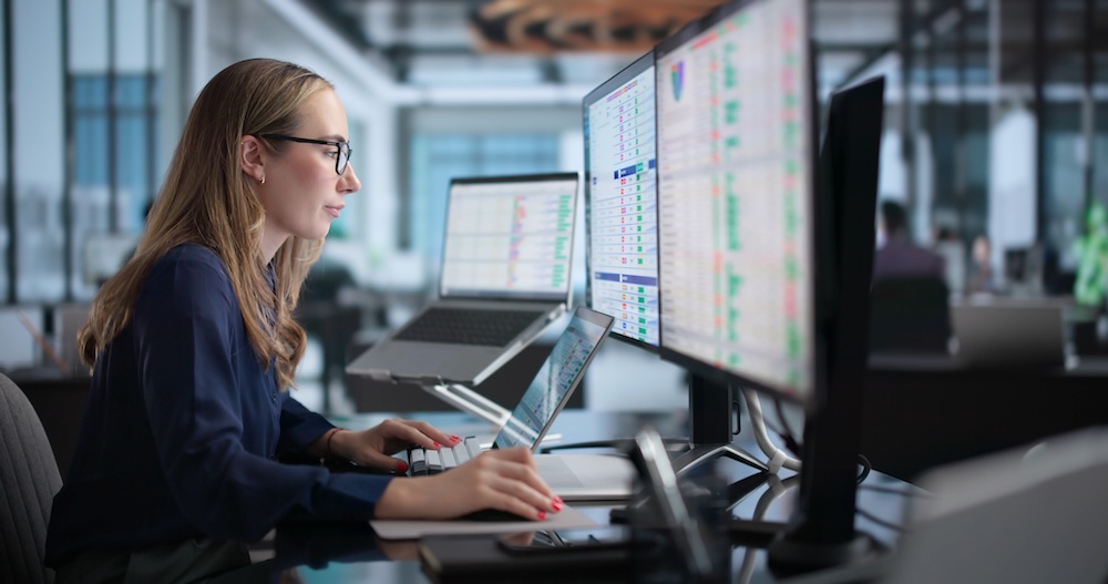 woman in office reviewing print management KPIs, print management software